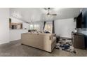 Open living room boasts vaulted ceilings, neutral tones, carpet flooring and sliding glass doors to the outdoor area at 2056 E San Tan Ct, Gilbert, AZ 85296