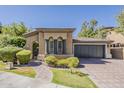 Charming single-story home with well-manicured landscaping, a tile roof, and a two-car garage at 3406 E Pyrenees Pass, Phoenix, AZ 85018