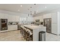 Bright, modern kitchen featuring a large island, stainless steel appliances, and ample cabinet space at 3406 E Pyrenees Pass, Phoenix, AZ 85018