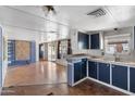 Open floor plan with kitchen, hardwood floors and modern lighting at 4065 E University Dr # 228, Mesa, AZ 85205