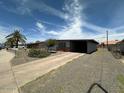 Charming single-story home with desert landscaping and covered parking at 513 S Cardinal Dr, Apache Junction, AZ 85120
