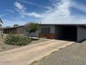 Charming single-story home with desert landscaping and covered parking at 513 S Cardinal Dr, Apache Junction, AZ 85120