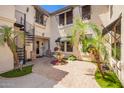 Inviting courtyard featuring a lovely water fountain, lush greenery, and a charming spiral staircase at 530 S Emerson St, Chandler, AZ 85225