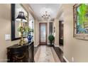 Elegant foyer with hardwood floors, a decorative mirror, and an ornate chandelier at 530 S Emerson St, Chandler, AZ 85225