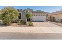 Charming home with a two-car garage, desert landscaping, and a paved driveway at 549 E Balao Dr, Phoenix, AZ 85085