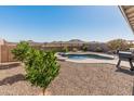 Backyard features a pool, desert landscaping, a grill, and mountain views at 549 E Balao Dr, Phoenix, AZ 85085