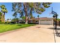 Exterior of the home with a long driveway and a basketball hoop near the street at 709 E Hayward Ave, Phoenix, AZ 85020