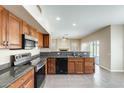 Functional kitchen with granite countertops, stainless steel appliances and wooden cabinets at 720 W Palo Verde St, Gilbert, AZ 85233