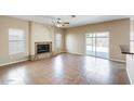 Spacious living room featuring tile flooring, a ceiling fan and fireplace at 720 W Palo Verde St, Gilbert, AZ 85233