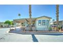 Cozy manufactured home boasts a covered carport and attractive landscaping, enhancing its curb appeal in a friendly neighborhood at 111 S Greenfield Rd # 547, Mesa, AZ 85206
