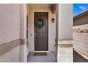 Inviting entryway featuring a craftsman-style door with decorative wreath and textured stucco columns at 1272 W Joshua Tree Ave, Queen Creek, AZ 85140