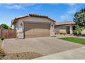 Charming single-story home with a well-manicured lawn and a paver driveway at 1272 W Joshua Tree Ave, Queen Creek, AZ 85140