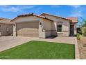 Charming single-story home with a well-manicured lawn and a paver driveway at 1272 W Joshua Tree Ave, Queen Creek, AZ 85140