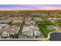 Expansive aerial view of a residential neighborhood highlighting a home with lush backyard, grass, and community landscape at 13820 W Weaver Ct, Litchfield Park, AZ 85340