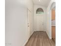 Bright entryway with wood-look floors, coat closet, and interior access door at 15460 W Mescal W St, Surprise, AZ 85379