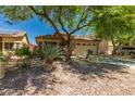 Charming single-Gathering home with lush landscaping, two-car garage, and inviting curb appeal at 15460 W Mescal W St, Surprise, AZ 85379