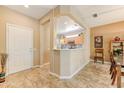 Welcoming entryway flows into an open-concept kitchen and dining area, featuring tile floors at 16857 W Villagio Dr, Surprise, AZ 85387
