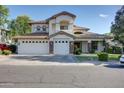 Charming two-story home boasting a three-car garage and desert landscaping at 1707 E Carob Dr, Chandler, AZ 85286