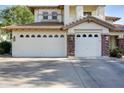 A spacious three-car garage with stone pillar accents at 1707 E Carob Dr, Chandler, AZ 85286