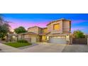 Beautiful two-story home with a three-car garage and meticulously kept front lawn at 18518 E Ashridge Dr, Queen Creek, AZ 85142