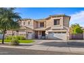 Inviting two-story home with a well-maintained lawn and attached three-car garage at 18518 E Ashridge Dr, Queen Creek, AZ 85142