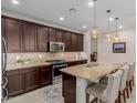 Gourmet kitchen featuring granite countertops, stainless steel appliances, and pendant lighting at 20603 W Alsap Rd, Buckeye, AZ 85396