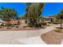 Lovely single-story home with lush landscaping and a welcoming entrance at 21824 S 226Th Pl, Queen Creek, AZ 85142