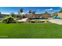 Spacious backyard with a pool, lounge chairs, and vibrant green turf at 2308 E Dry Wood Rd, Phoenix, AZ 85024
