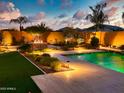 Backyard with a pool, fire pit, and lush landscaping, perfect for outdoor entertaining at 2308 E Dry Wood Rd, Phoenix, AZ 85024
