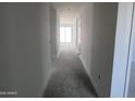 A view down a long hallway in the interior of a home at 24104 W Bowker St, Buckeye, AZ 85326