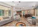 Spacious living room with tile flooring, ceiling fan, with an open view of the dining and kitchen area at 27088 W Sequoia Dr, Buckeye, AZ 85396