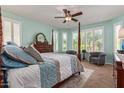 Bright main bedroom with bay windows, ceiling fan, and soothing paint color create a relaxing atmosphere at 27088 W Sequoia Dr, Buckeye, AZ 85396
