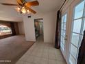 View from living room to kitchen with backyard access via French doors and view of front yard window at 2934 W Northview Ave, Phoenix, AZ 85051