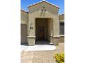 Covered front porch with decorative door and address plaque at 30776 W Earll Dr, Buckeye, AZ 85396