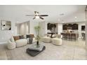 Bright living room featuring modern furnishings, stylish decor, and an open layout connecting to the kitchen at 30776 W Earll Dr, Buckeye, AZ 85396
