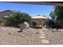 Expansive backyard featuring desert landscaping, a rock feature, and a charming gazebo for outdoor relaxation at 4581 E Apricot Ln, Gilbert, AZ 85298