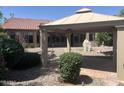 Backyard features a covered patio, desert landscaping, and ample privacy at 4581 E Apricot Ln, Gilbert, AZ 85298