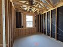 Interior view of a bedroom's framework during construction, featuring a window opening for natural light at 46850 W Old Timer Rd, Maricopa, AZ 85139