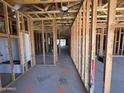 View of the home's framed interior, including visible framework for walls, ceilings, and plumbing at 46850 W Old Timer Rd, Maricopa, AZ 85139