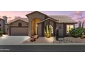 Charming single-story home featuring desert landscaping, a two-car garage, and a covered front entry at 6080 S Jojoba Ct, Gold Canyon, AZ 85118