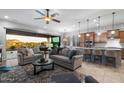 Spacious living room with modern furnishings that seamlessly connect to the gourmet kitchen and outdoor spaces at 8633 E Kael Cir, Mesa, AZ 85207
