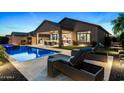 Inviting backyard oasis with a sparkling pool, lounge chairs, and covered patio perfect for outdoor entertaining at 8633 E Kael Cir, Mesa, AZ 85207