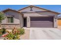 Charming single-story home featuring a two-car garage, desert landscaping, and neutral earth tone colors at 948 E Wiley Way, Casa Grande, AZ 85122