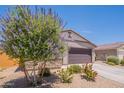 Charming single-story home featuring a two-car garage, desert landscaping, and neutral earth tone colors at 948 E Wiley Way, Casa Grande, AZ 85122
