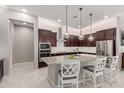 Kitchen with granite counters, stainless appliances, recessed lights, and seating at the island at 1036 W Siebold Tree Ave, Queen Creek, AZ 85140