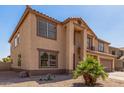 Two-story home featuring a neutral stucco exterior, a two-car garage, and a low-maintenance desert landscape at 11511 E Renata Ave, Mesa, AZ 85212