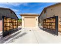 A detached two-car garage with an automatic door and custom gate at 11737 N 143Rd Dr, Surprise, AZ 85379