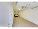 Spacious three car garage with bright lighting and neutral epoxy flooring at 11737 N 143Rd Dr, Surprise, AZ 85379