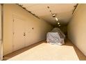 Spacious two-car garage with epoxy floors and a covered vehicle at 11737 N 143Rd Dr, Surprise, AZ 85379