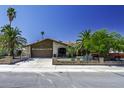 Inviting single-story home with a well-maintained lawn, mature trees, and a gated driveway at 1191 E Avenida Fresca St, Casa Grande, AZ 85122
